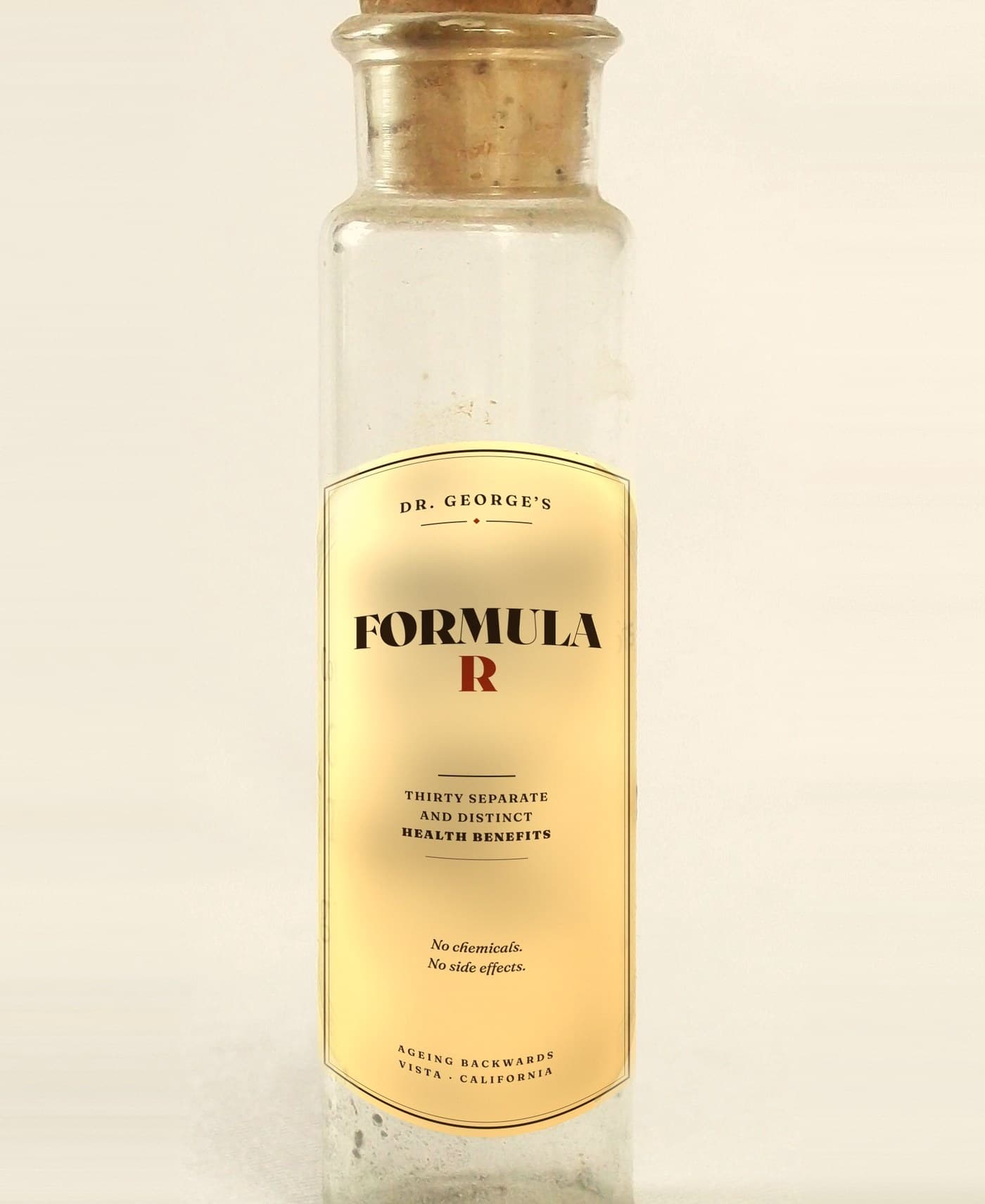 An antique corked medicine bottle labelled “Dr. George’s Formula R — thirty separate and distinct health benefits. No chemicals. No side effects.”