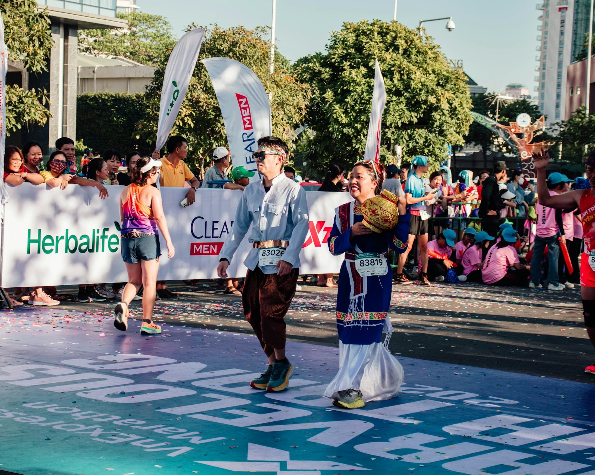 Runners and a cheering crowd at a road race